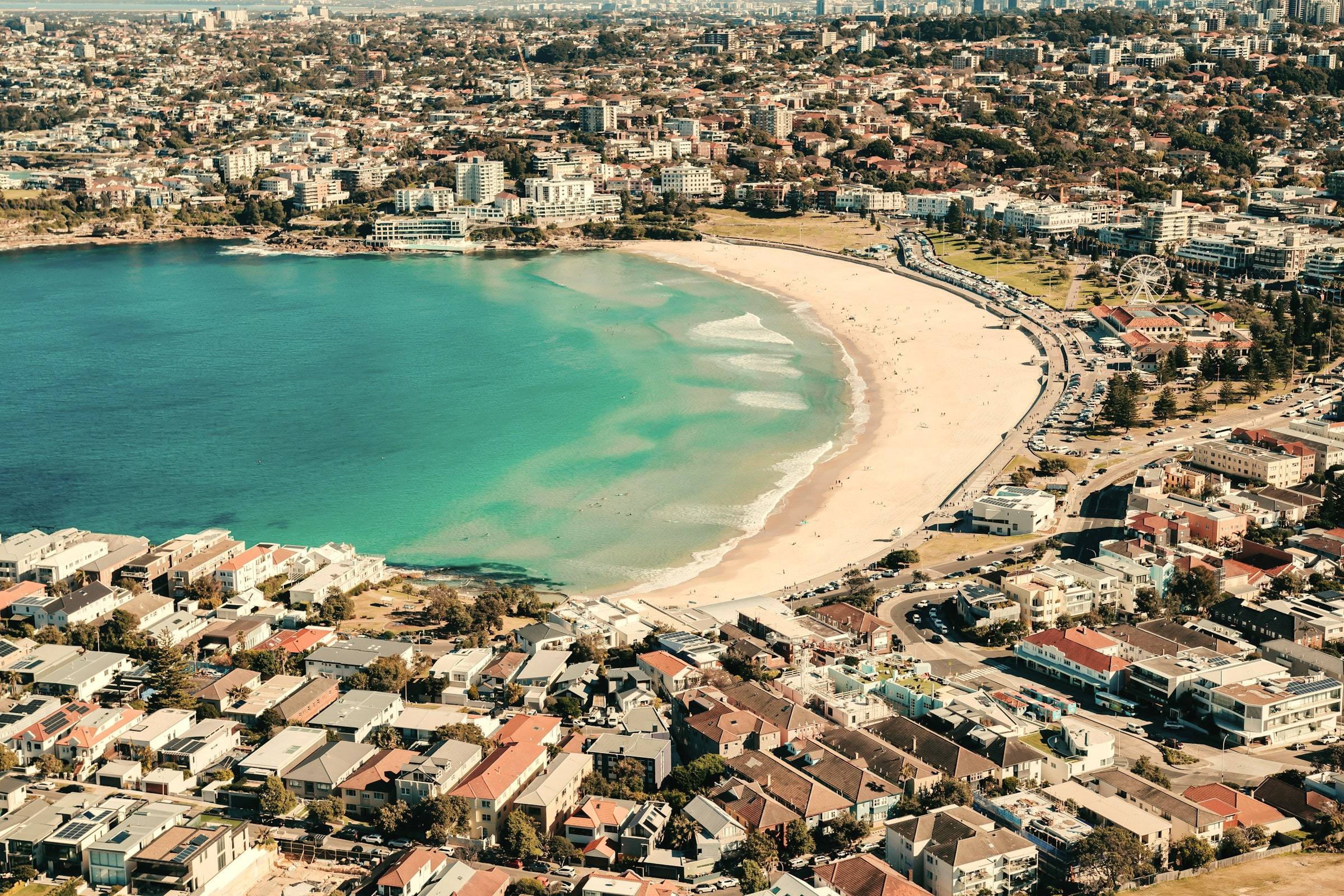 Aerial view of Bondi Beach: the curve of sand and turquoise water, with the suburb behind